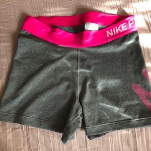 Gray and pink Nike Pros